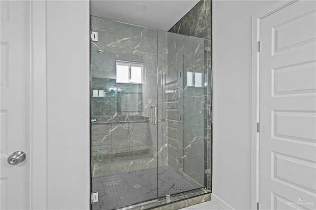 bathroom with a marble finish shower