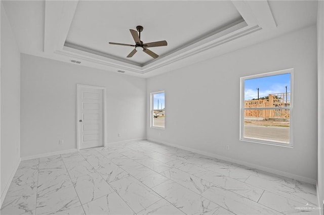 unfurnished room featuring marble finish floor, visible vents, baseboards, and a raised ceiling