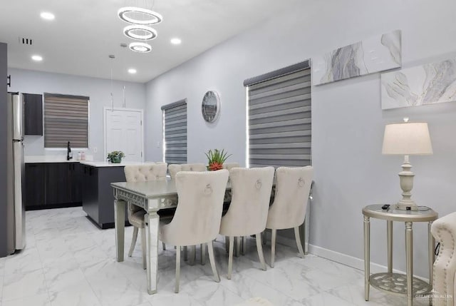 dining area featuring marble finish floor, baseboards, a notable chandelier, and recessed lighting