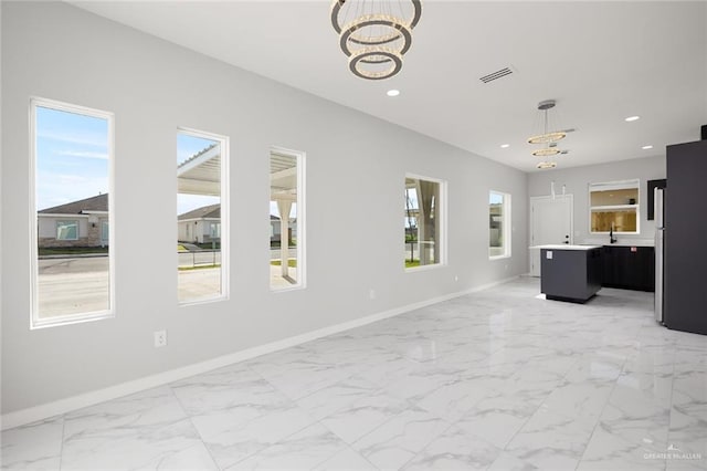 unfurnished living room featuring marble finish floor, recessed lighting, visible vents, a chandelier, and baseboards