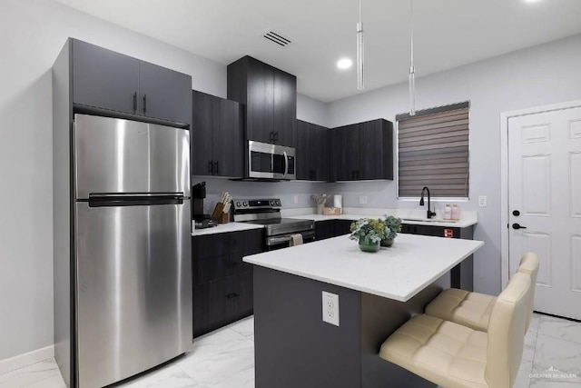 kitchen with visible vents, appliances with stainless steel finishes, a center island, marble finish floor, and light countertops