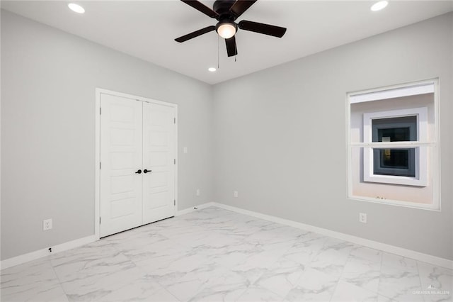 unfurnished bedroom featuring marble finish floor, recessed lighting, and baseboards