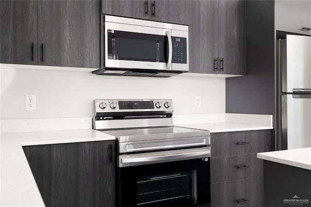 kitchen featuring modern cabinets, appliances with stainless steel finishes, and light countertops