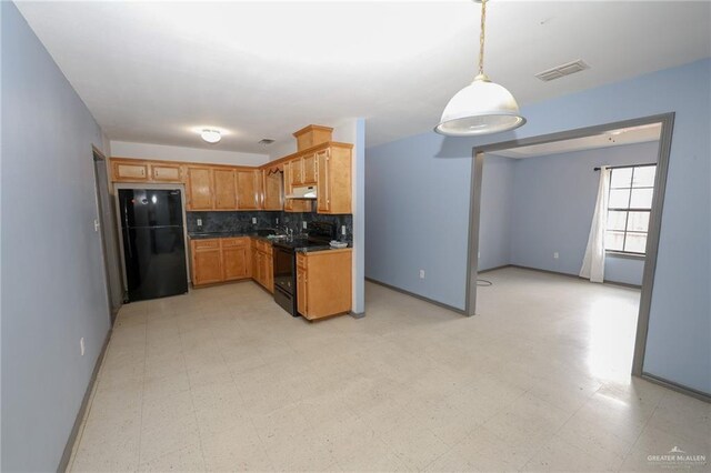 kitchen featuring tasteful backsplash, visible vents, under cabinet range hood, light floors, and black appliances