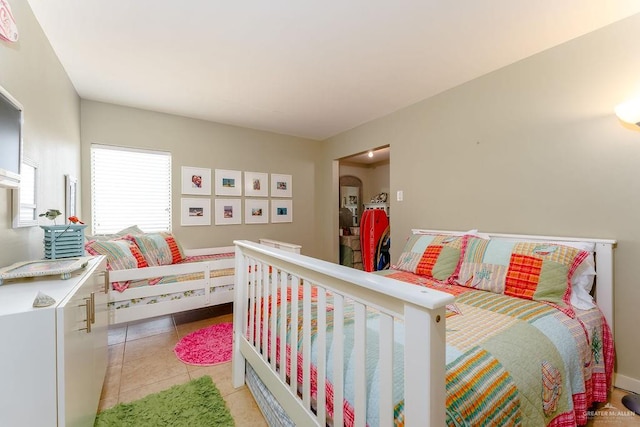 bedroom with light tile patterned floors