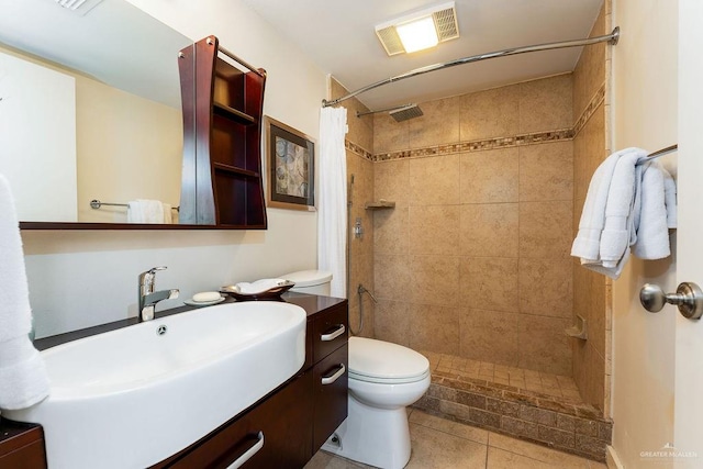 bathroom featuring tile patterned flooring, a shower with curtain, vanity, and toilet