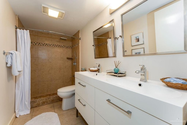 bathroom with tile patterned flooring, vanity, curtained shower, and toilet