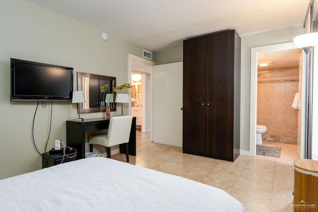 tiled bedroom featuring connected bathroom