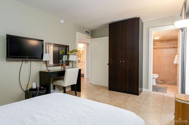 114 E Tarpon St Unit 201, South Padre Island, TX 78597 - tiled bedroom featuring connected bathroom