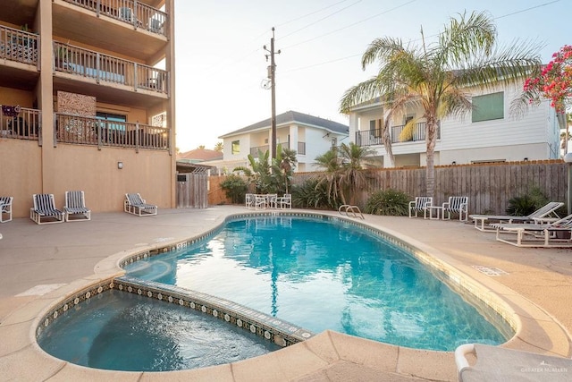 view of pool featuring an in ground hot tub and a patio