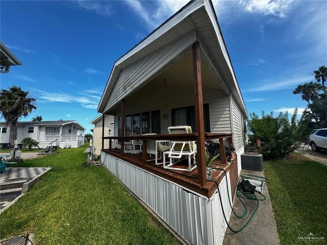 back of property with a lawn and cooling unit