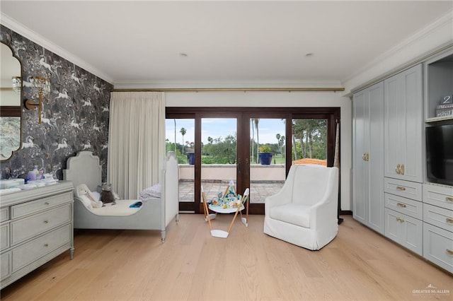 sitting room featuring ornamental molding and light wood-type flooring