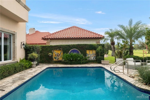 view of pool featuring a fenced in pool and a patio