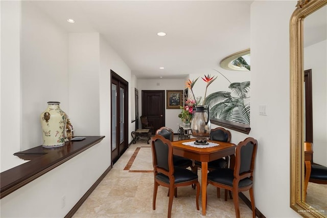 hallway featuring baseboards and recessed lighting