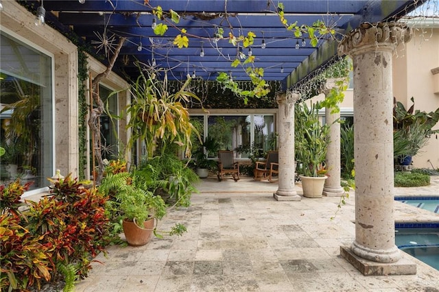 view of patio featuring an outdoor pool and a pergola