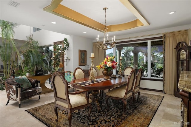 dining area with a tray ceiling, recessed lighting, visible vents, and a notable chandelier