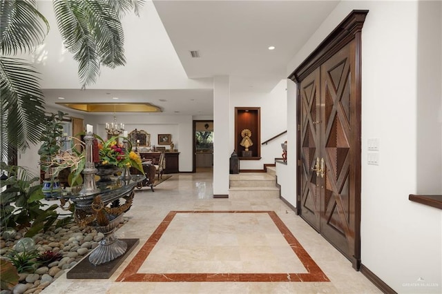 foyer entrance with recessed lighting, visible vents, stairway, and baseboards