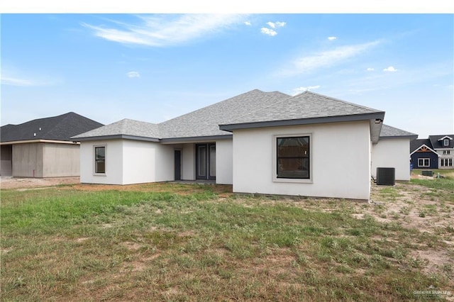 9817 Heights, Harlingen, TX 78552 - rear view of property featuring a lawn, roof with shingles, and stucco siding