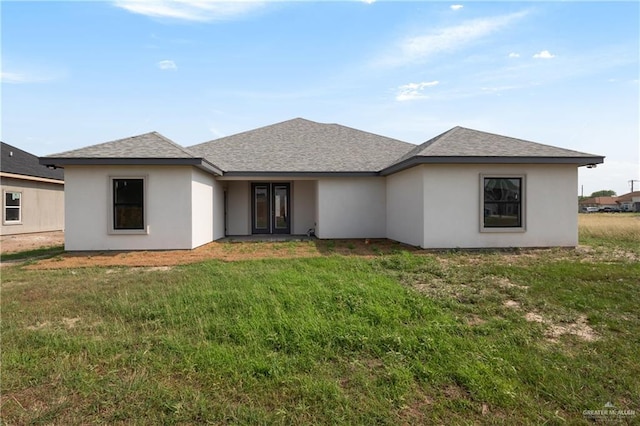 9817 Heights, Harlingen, TX 78552 - view of front of home featuring a front lawn, french doors, stucco siding, and a shingled roof