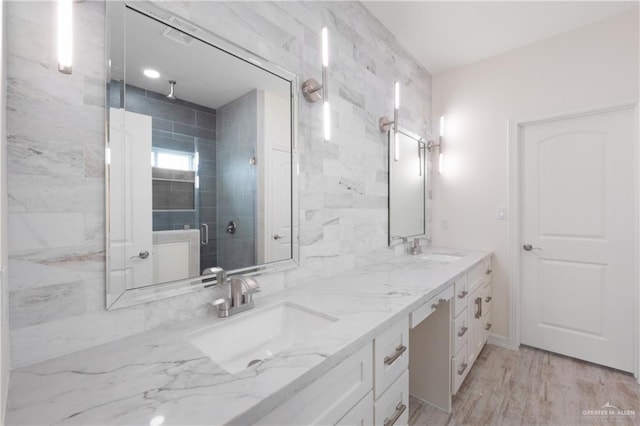 9817 Heights, Harlingen, TX 78552 - bathroom featuring a shower stall, double vanity, and wood finished floors