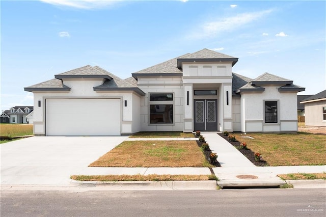 9817 Heights, Harlingen, TX 78552 - prairie-style house featuring an attached garage, concrete driveway, a front yard, roof with shingles, and french doors