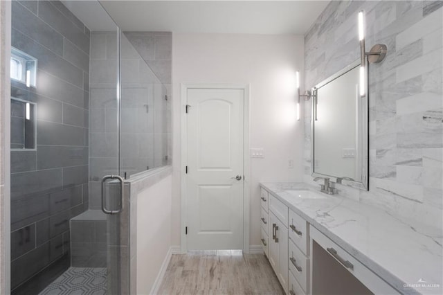 9817 Heights, Harlingen, TX 78552 - bathroom with vanity, a stall shower, wood finished floors, and baseboards