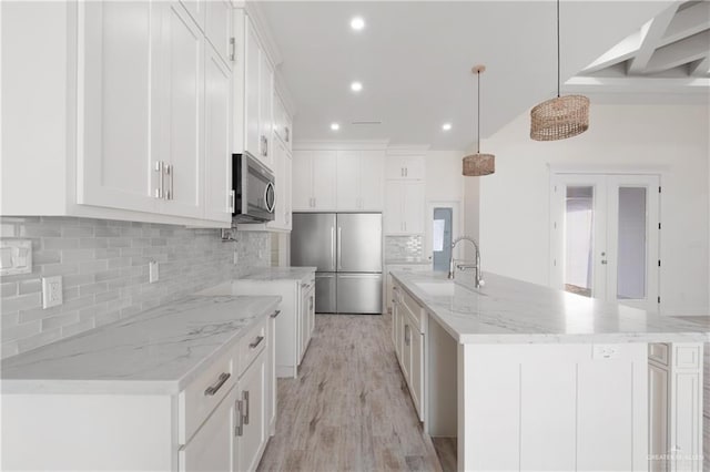 9817 Heights, Harlingen, TX 78552 - kitchen featuring stainless steel appliances, a sink, recessed lighting, tasteful backsplash, and white cabinetry