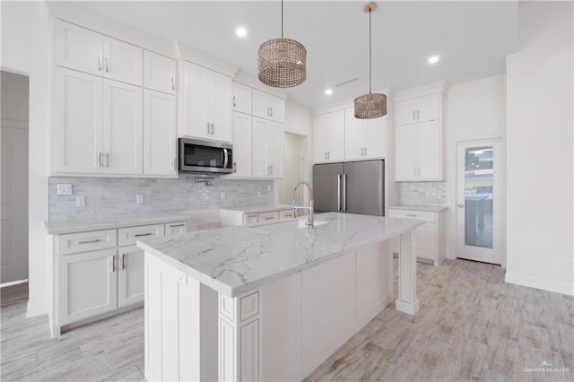 9817 Heights, Harlingen, TX 78552 - kitchen featuring stainless steel appliances, a sink, backsplash, recessed lighting, and a kitchen island with sink