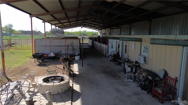 12431 Ware Rd, Edinburg, TX 78541 - view of patio featuring an outbuilding, an outdoor fire pit, an exterior structure, cooling unit, and a carport