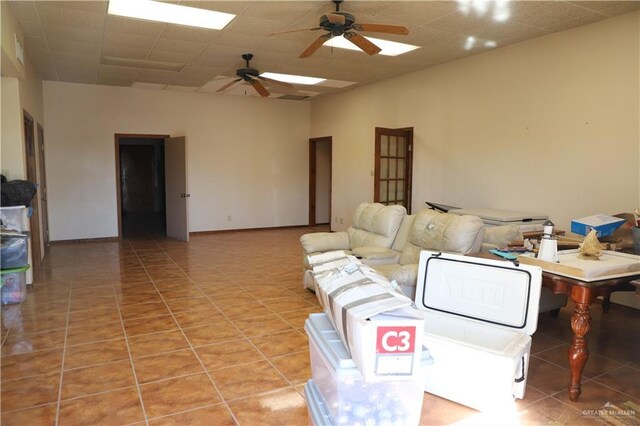 12431 Ware Rd, Edinburg, TX 78541 - living room featuring light tile patterned floors, a paneled ceiling, and ceiling fan
