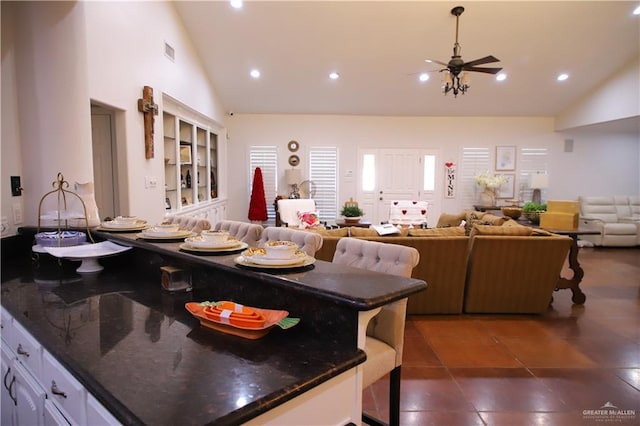 12431 Ware Rd, Edinburg, TX 78541 - kitchen featuring visible vents, high vaulted ceiling, recessed lighting, white cabinetry, and open floor plan