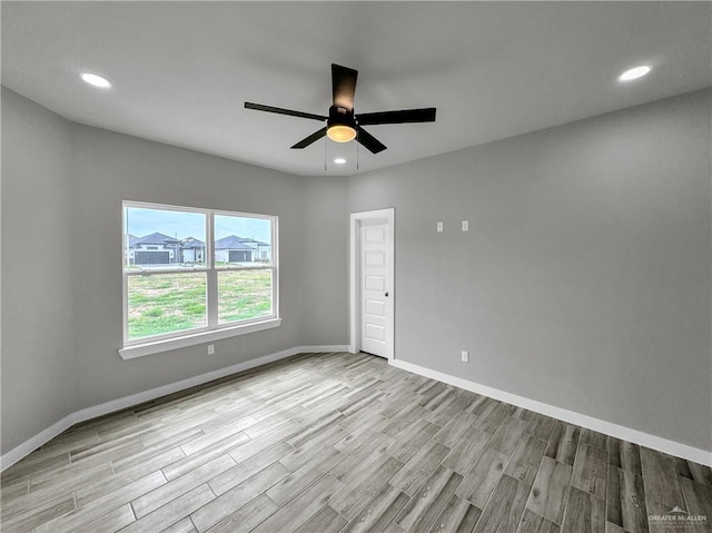 unfurnished room featuring ceiling fan and light hardwood / wood-style floors