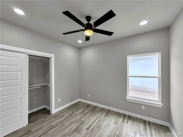 unfurnished bedroom with a closet, ceiling fan, and light hardwood / wood-style flooring