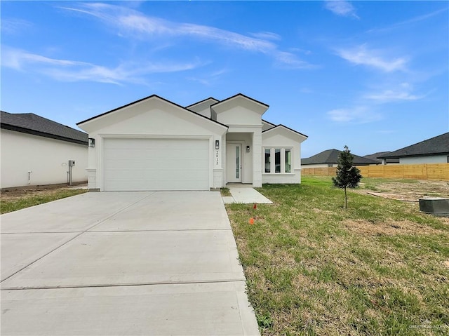 ranch-style home with a garage and a front lawn