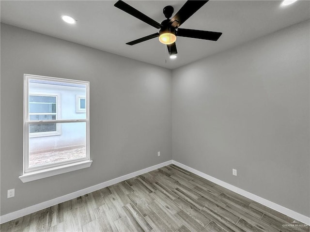 unfurnished room featuring ceiling fan and light wood-type flooring