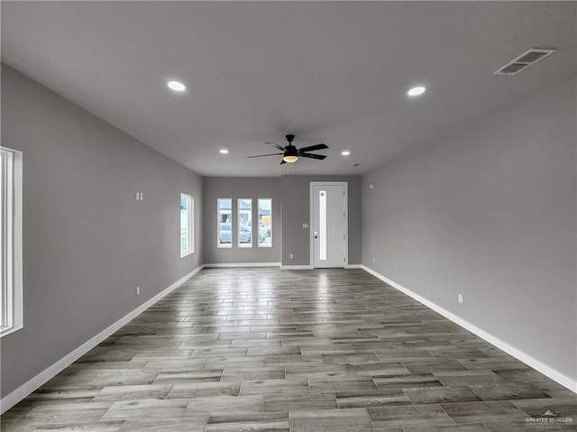 spare room with ceiling fan and light wood-type flooring