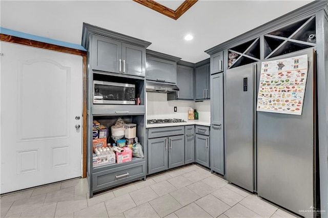 kitchen featuring gray cabinets, light tile patterned floors, and stainless steel appliances