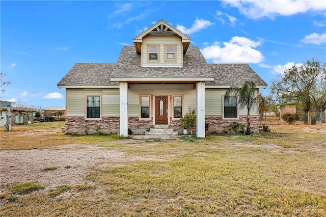 craftsman inspired home featuring a porch and a front yard