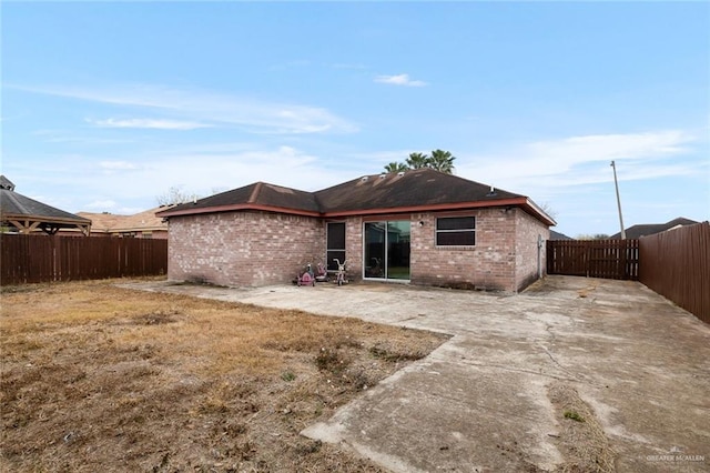 rear view of property with a patio and a yard