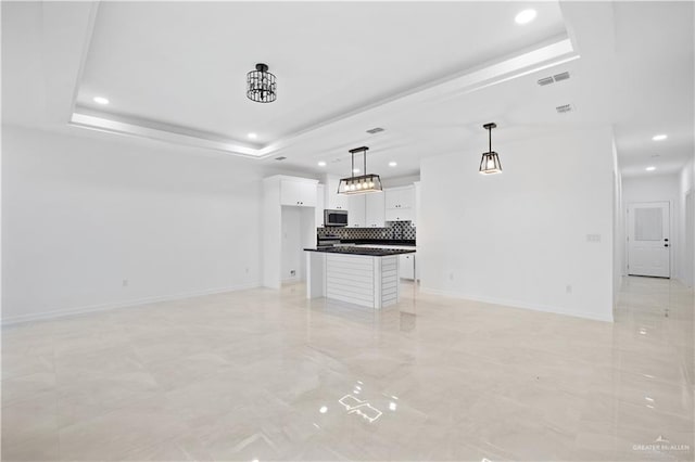 unfurnished living room featuring a raised ceiling