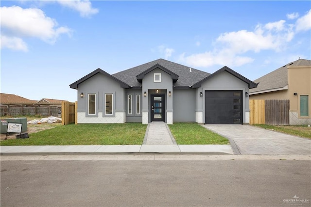 view of front of property with a garage and a front lawn