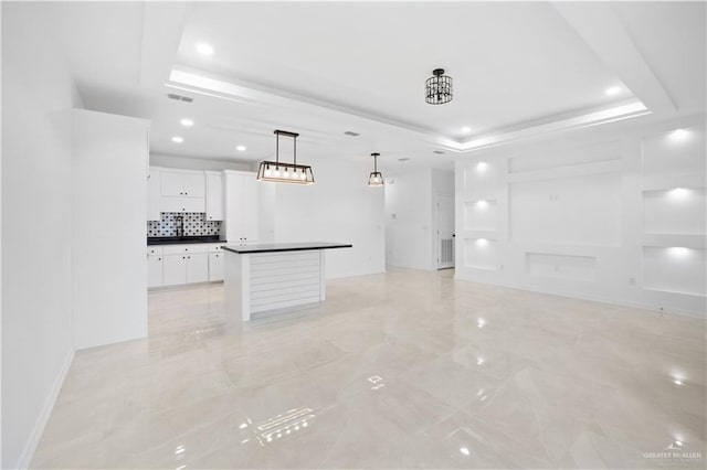 unfurnished living room with a raised ceiling