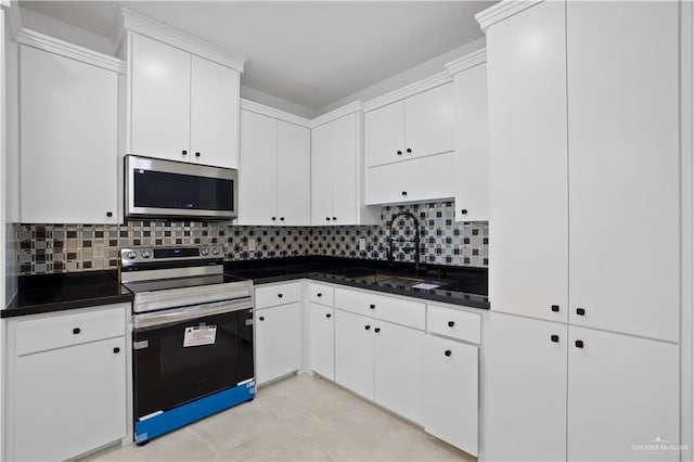 kitchen featuring white cabinetry, appliances with stainless steel finishes, sink, and tasteful backsplash