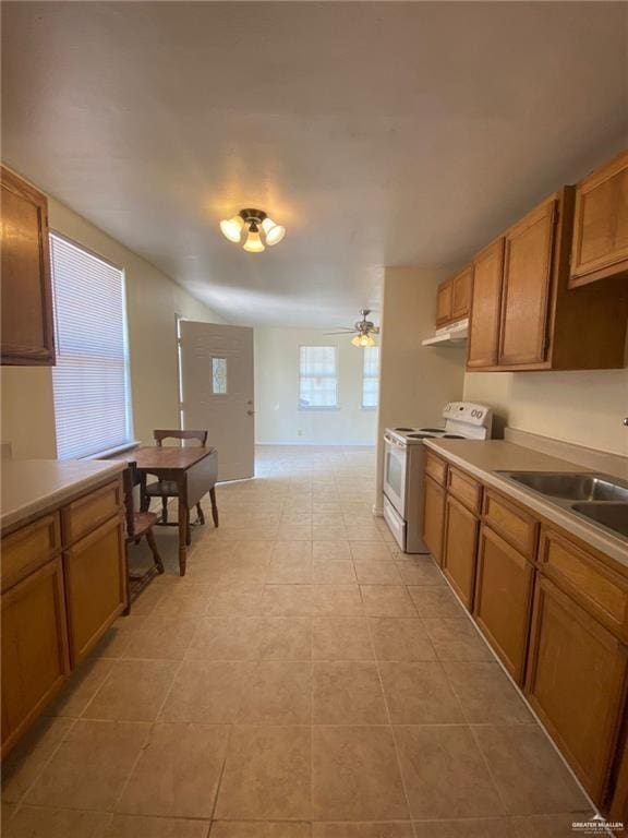 kitchen featuring white electric stove, sink, light tile patterned floors, and ceiling fan