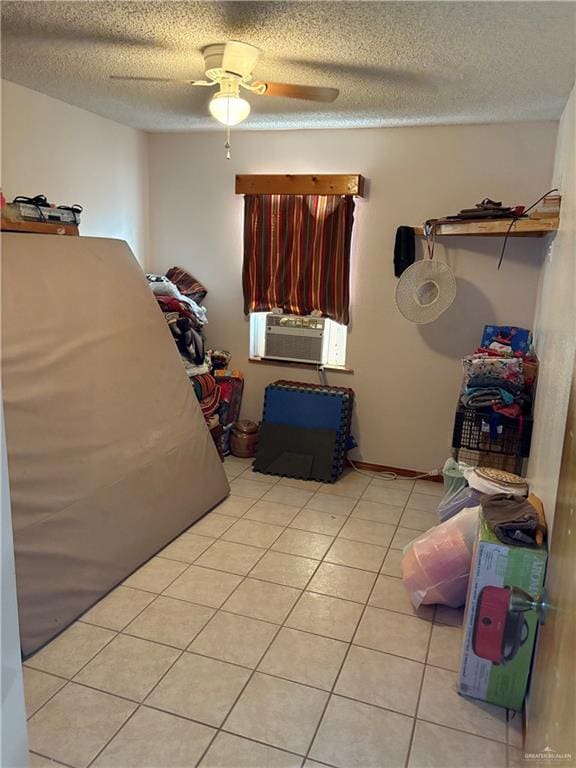 clothes washing area with ceiling fan, cooling unit, light tile patterned flooring, and a textured ceiling