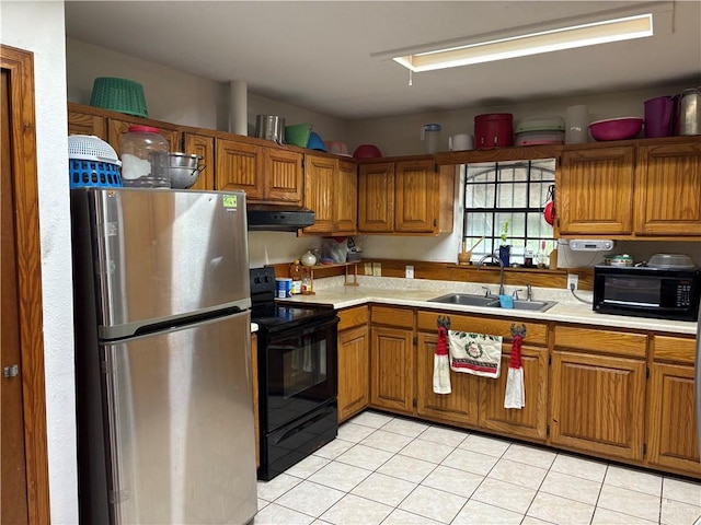 kitchen featuring black appliances, ventilation hood, sink, and light tile patterned floors