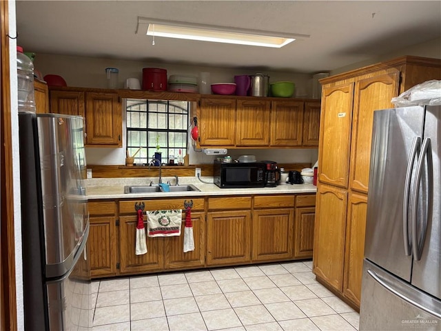 kitchen with stainless steel fridge, sink, and light tile patterned flooring