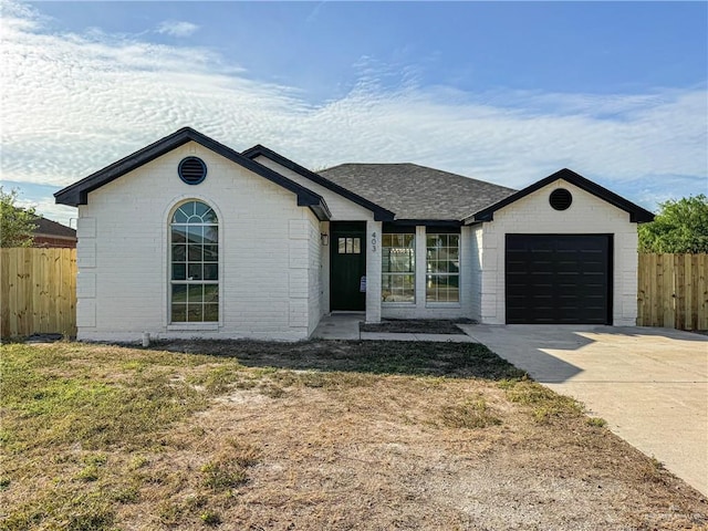 ranch-style house featuring a front lawn and a garage