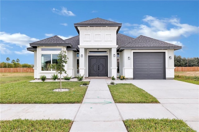 view of front of home with a front lawn and a garage