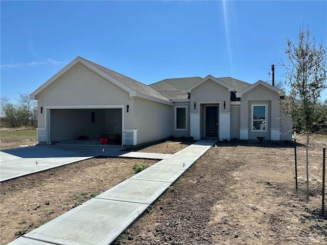 ranch-style house featuring stucco siding, an attached garage, concrete driveway, and a shingled roof